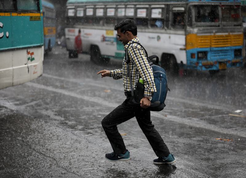 A man runs through heavy rain in Kolkata, India. A tropical depression continued during Cyclone Asani and heavy rainfall hit West Bengal and Andhra Pradesh. EPA