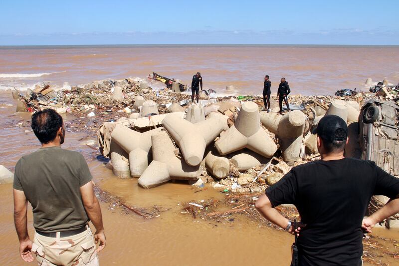 People look for survivors after flooding in Derna, Libya. AP