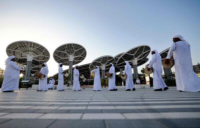 A group of traditional Emirati musicians perform at the entrance of Expo 2020 Dubai. AFP