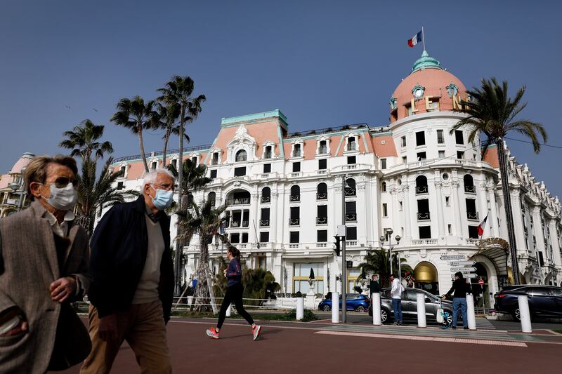 People walk on the 'Promenade de Anglais' in Nice, France. The Winter Resort Town of the Riviera has become a Unesco World Cultural Heritage Site.