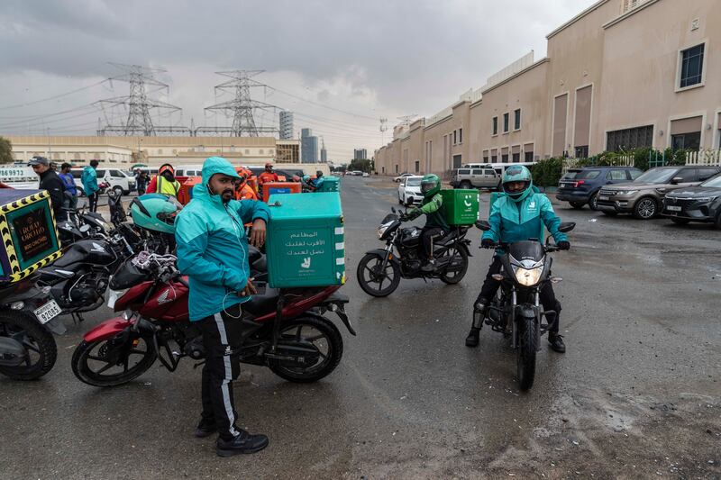 Delivery riders park up as rain falls in Dubai this week. Police urged drivers to be cautious in wet conditions. Antonie Robertson / The National


