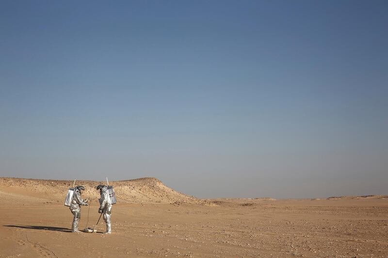 Two scientists test space suits and a geo-radar for use in a future Mars mission in the Dhofar desert of southern Oman on Wednesday, Feb. 7, 2018. The desolate desert resembles Mars so much that more than 200 scientists from 25 nations organized by the Austrian Space Forum are using it for the next four weeks to field-test equipment. (AP Photo/Sam McNeil)