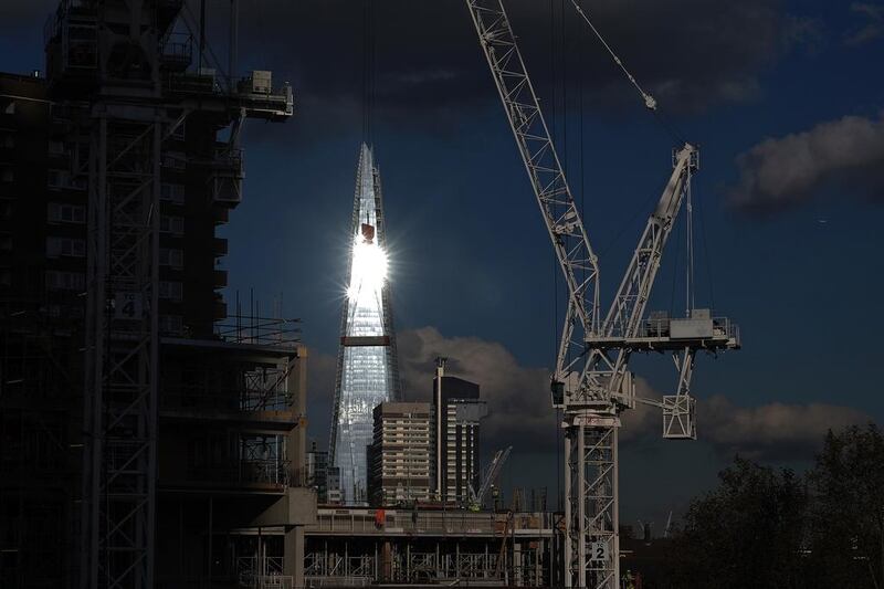 The sun reflects off the windows of the Shard skyscraper as construction cranes stand above building works at the Elephant & Castle Regeneration site. Middle Eastern SWFs, known for buying large trophy buildings in London and other key European cities, signed deals to buy US$6.5 billion worth of property in the first nine months of this year. Simon Dawson / Bloomberg