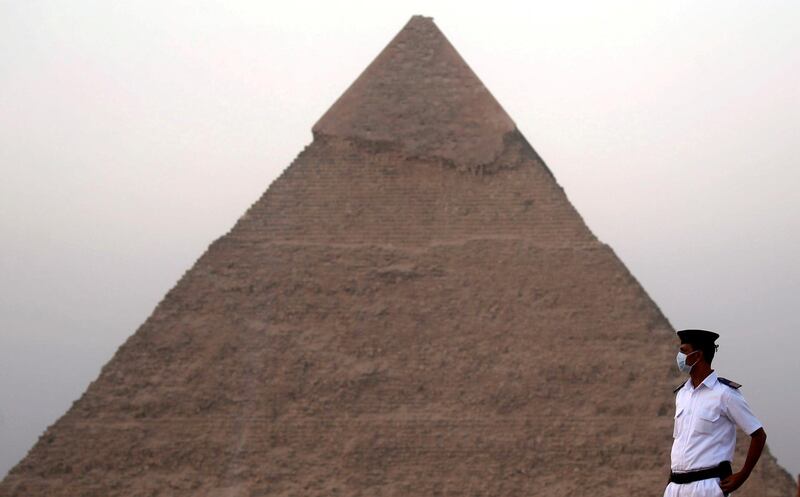 An Egyptian policeman wearing a protective face mask takes his position, in front of the Pyramid of Khufu or Pyramid of Cheops during the opening of a new restaurant called 9 Pyramids Lounge. Reuters