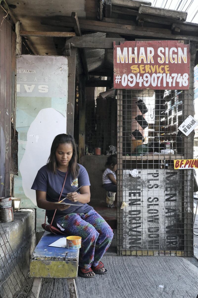 Dolly Paberecio, 28, runs a jeepney sign-board shop with her husband in Manila. Jake Verzosa