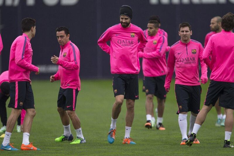 Barcelona players Marc Bartra, left, Xavi, second left, Gerard Pique, centre, and Lionel Messi, right, shown during a team training session on Saturday. Alejandro Garcia / EPA / November 29, 2014 