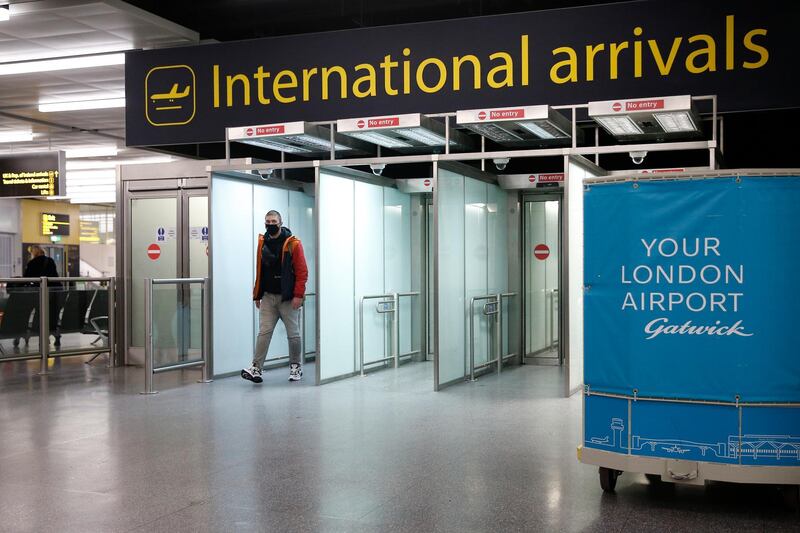 LONDON, ENGLAND - FEBRUARY 06: A traveler arrives at  the North Terminal at Gatwick Airport on February 6, 2021 in London, England. The UK Government has confirmed that anyone travelling to the UK from a country on the UK's travel ban "red list" from 15 February will be required to quarantine in a government-approved facility, such as a hotel room, for 10 days. (Photo by Hollie Adams/Getty Images)