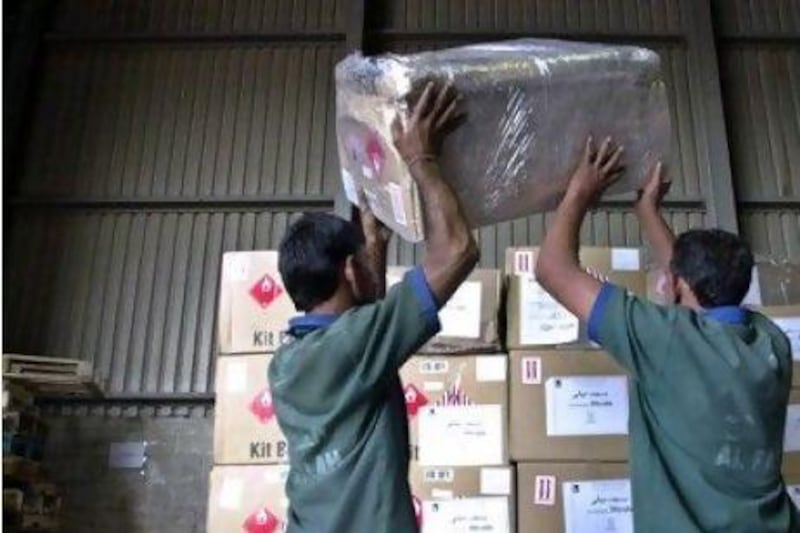 Airport staff in the UAE prepare cargo for shipment to Iraq. Operators say the high fees to fly cargo into Iraq are unfeasible.