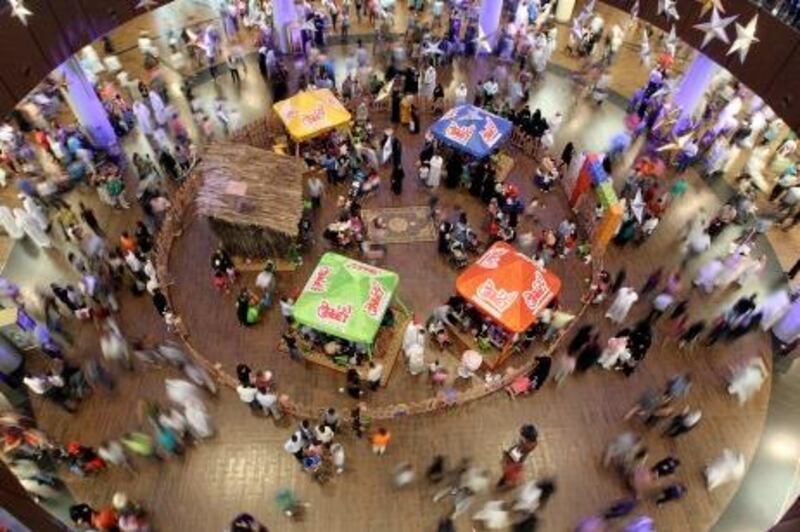 Emirati families spend the early hours of September 1, 2011 at a shopping mall in the Gulf emirate of Dubai, as Muslims celebrate the third and last day of the Eid al-Fitr holiday which marks the end of the holy fasting month of Ramadan. Shopping malls are a major attraction in the Gulf during the holidays due to soaring temperatures and high levels of humidity that obstruct outdoor activities during day time in summer. AFP PHOTO/KARIM SAHIB
 *** Local Caption ***  726322-01-08.jpg