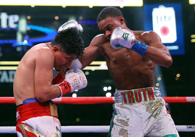 Mikey Garcia, left, takes a blow to the head from Errol Spence Jr. during the 10th round of the IBF welterweight championship boxing bout Saturday, March 16, 2019, in Arlington, Texas. (AP Photo/Richard W. Rodriguez)