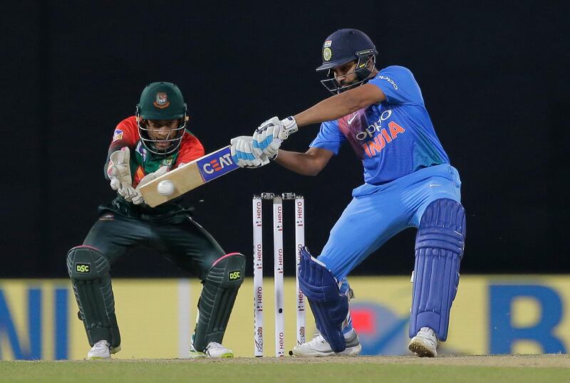 India's Rohit Sharma plays a shot against Bangladesh as Mushfiqur Rahim watches during their second Twenty20 cricket match in Nidahas triangular series in Colombo, Sri Lanka, Wednesday, March 14, 2018. (AP Photo/Eranga Jayawardena)