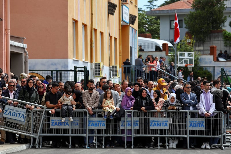 People wait for Mr Erdogan outside a polling station in Istanbul. Reuters
