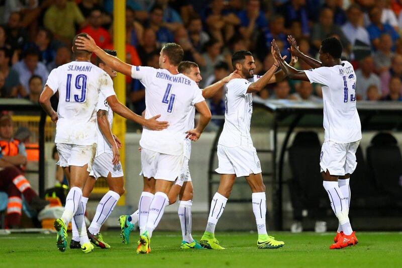Leicester forward Riyad Mahrez, second right, is congratulated by teammates after scoring the second goal against Club Brugge. Leicester won the match 3-0. Dean Mouhtaropoulos / Getty Images