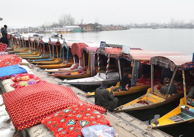 Kashmiri boatmen wait for tourists on the banks Dal Lake in Srinagar, the summer capital of Indian Kashmir. EPA