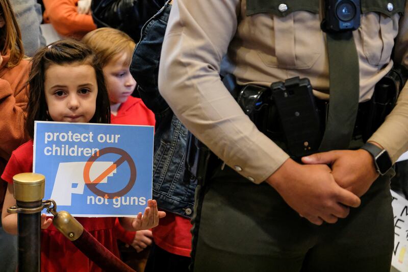 A child holds a sign inside the Tennessee State Capitol during a protest to end gun violence and support stronger gun laws after a deadly shooting at the Covenant School in Nashville. Reuters