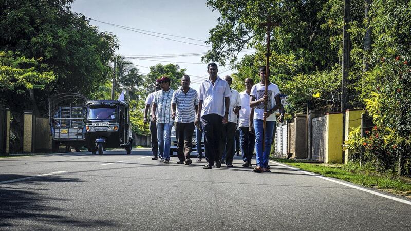 A funeral procession walks down the road in Negombo, Sri Lanka, April 23, 2019. Jack Moore / The National. 