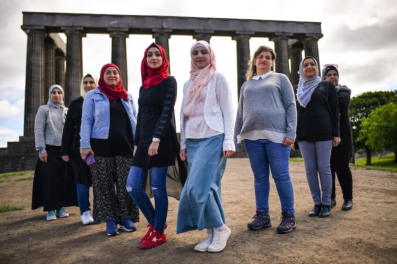 EDINBURGH, SCOTLAND - JULY 01: A group of Syrian refugees hold a photo call on Calton Hill as they look to raise £25,000 to put on their play Euripdes The Trojan Women on July 1, 2019 in Edinburgh, Scotland.  A brand new, haunting and uplifting adaptation of Euripides great anti-war tragedy, written and acted by a cast of Syrian refugees living in Glasgow, performed in Arabic (with subtitles) and English.  (Photo by Jeff J Mitchell/Getty Images)