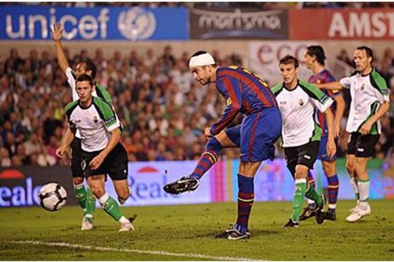 Gerard Pique scores Barcelona's third goal against Racing Santander after an exquisite back heel from Zlatan Ibrahimovic.