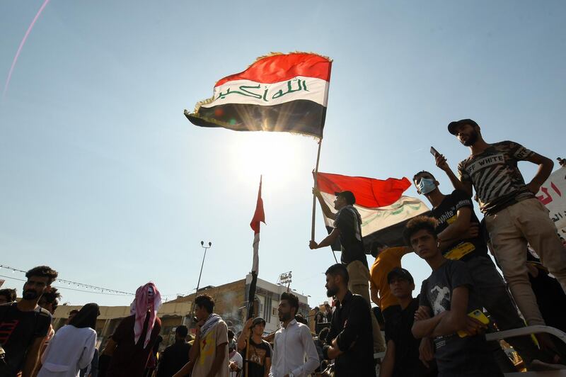 Iraqi demonstrators chant slogans during a gathering in Haboubi Square in the southern city of Nasiriyah on October 28, 2020, to demand a total overhaul of a political system.  / AFP / Assaad AL-NIYAZI
