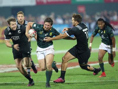 Sevens World Rugby Dubai Series - South Africa v New Zealand - Dubai Rugby Sevens - Dubai, UAE - December 2, 2017 South Africa's Kwagga Smith in action with New Zealand's  Tim Mikkelson and Joe Webber. REUTERS/Satish Kumar