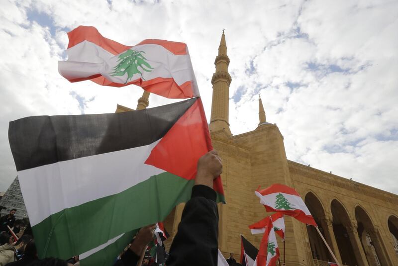 Lebanese protesters wave national and Palestinian flags during a demonstration in downtown Beirut on December 8, 2017 against the US decision to recognise Jerusalem as the capital of Israel. Joseph Eid / AFP