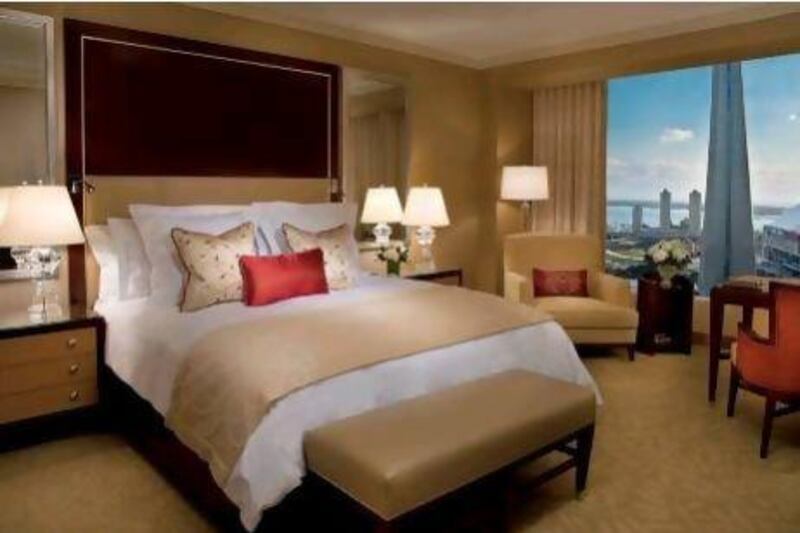 The simple, beige rooms at the Ritz-Carlton in Toronto offer a magnificent view of the CN Tower and Lake Ontario. Courtesy of The Ritz-Carlton