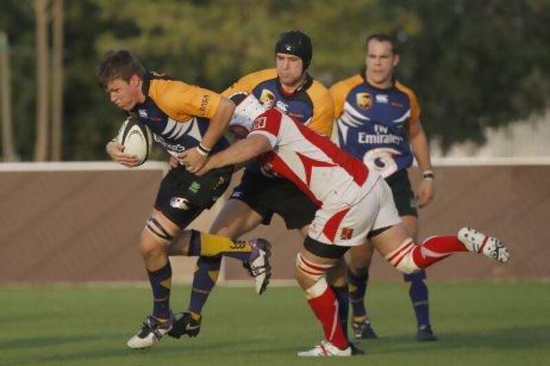 A Bahrain defender, right, tries to stop the Dubai ball carrier during the Hurricanes' 11-7 win on Friday.