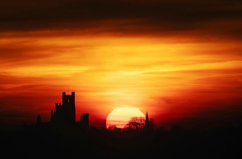 The sun rises behind Ely Cathedral, Ely, east England. AP Photo