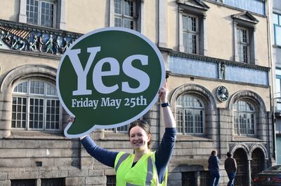 Repeal campaigner Stephanie Fleming holds up a banner next to the River Liffey in Dublin, Ireland. Claire Corkery/ The National