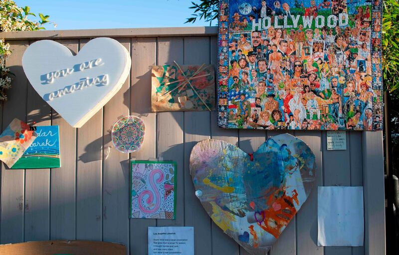 Works of art are displayed as part of artist Ann Morrow Johnson's "Museum of Quarantine on Quebec" on the fence of her home in Hollywood, California, USA. AFP