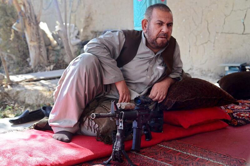 Afghan police commander Sultan Mohammed rests at a house in the Panjwai district of Kandahar province. A captured Taliban rifle at his side, commander Mohammed now controls what once a hornet’s nest of insurgents. Javed Tanveer / AFP 