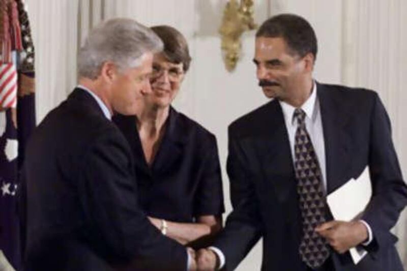 In a 1999 photo, President Clinton shakes hand with his deputy attorney general, Eric Holder. Mr Holder is President-elect Barack Obama's top choice to be the next attorney general.