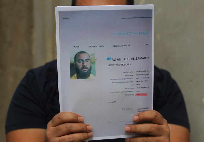 An Iraqi man holds printed profiles of Abu Bakr al-Baghdadi released by Iraq authorities on February 6, 2018.
Iraqi authorities issued a new list of "internationally wanted terrorists," headed by Islamic State group leader Abu Bakr al-Baghdadi.  / AFP PHOTO / AHMAD AL-RUBAYE