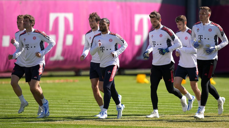 Bayern's Joshua Kimmich, from left, Thomas Muller, Leon Goretzka, Serge Gnabry, Sven Ulreich, Josip Stanisic and Christian Fruechtl warm up during a training session. AP