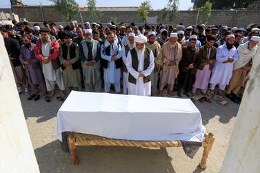 Afghan men pray in front of the coffin of one of three female media workers who were shot and killed by unknown gunmen, in Jalalabad, Afghanistan. Reuters