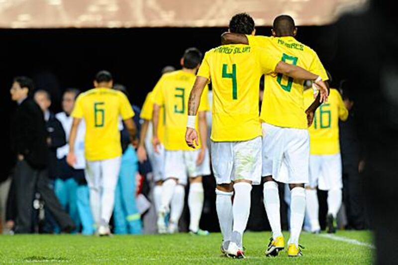 Brazil players trudge off the pitch dejected following their shoot-out defeat to Paraguay.