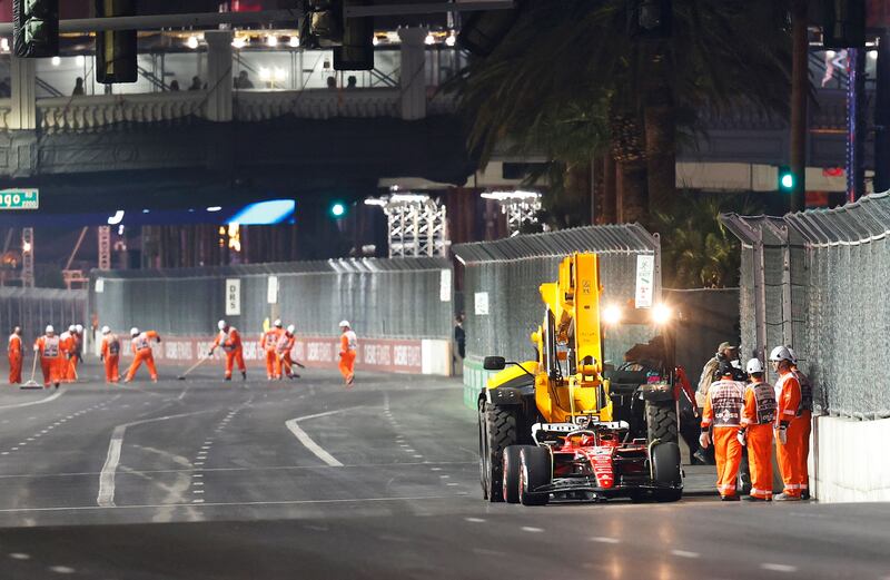 The car of Carlos Sainz is removed from the circuit on a truck after stopping on track during practice. AFP