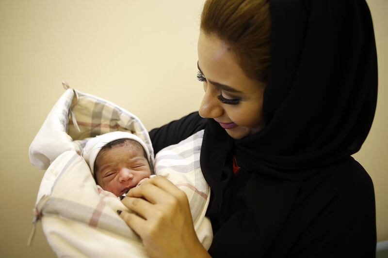 Mahra Al Yaqoobi holds her niece Noura Al Nadhari, who arrived at 5.52am on Eid Al Adha on Monday at the Corniche Hospital in Abu Dhabi. Ravindranath K / The National