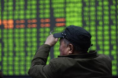 A stock investor sits in front of a display screen at a brokerage house in Hangzhou, China. The country's stock market has been the best performer of the year, with share prices up a third. EPA 