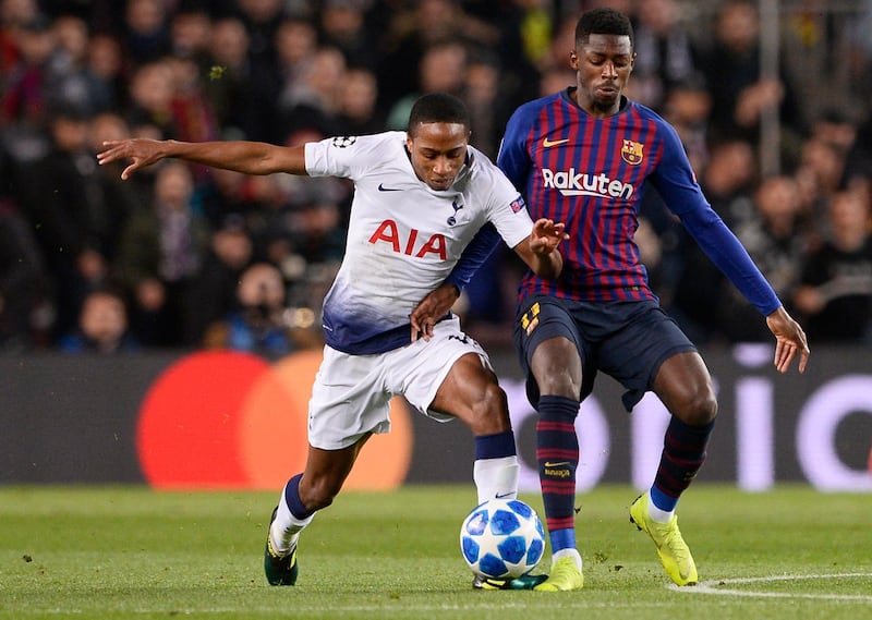 Tottenham defender Kyle Walker-Peters, left, is dispossessed by Barcelona's French forward Ousmane Dembele during Tuesday's Uefa Champions League match at Camp Nou. Dembele scored Barca's goal in a 1-1 draw, a result that saw both teams advance to the last 16. AFP