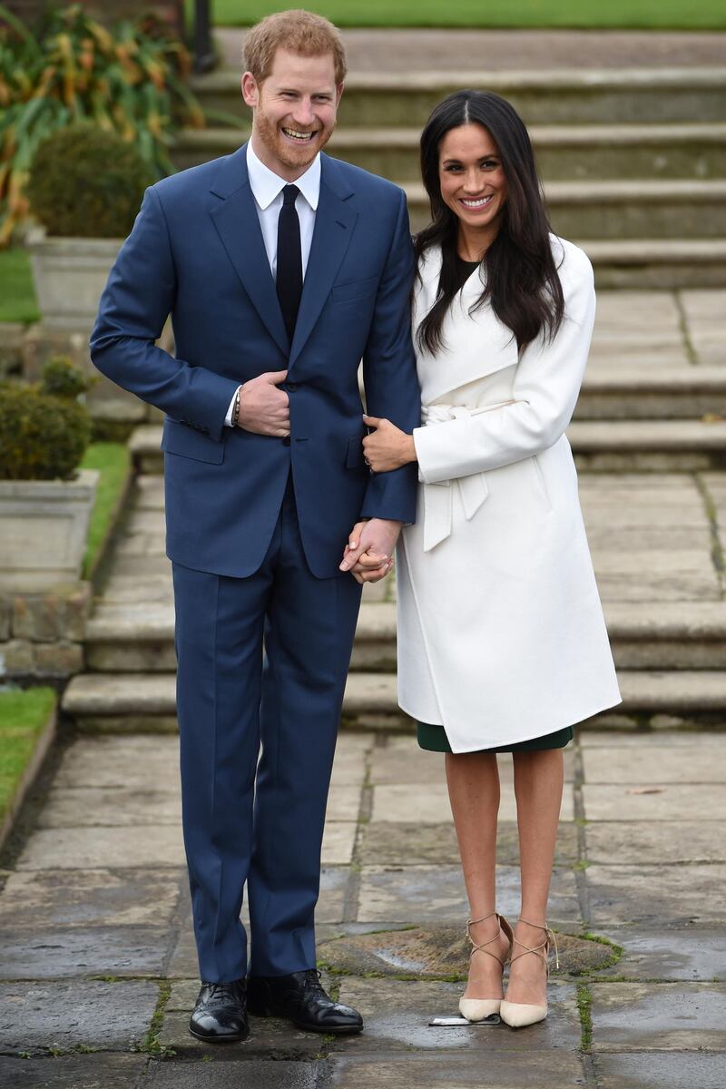 Britain's Prince Harry poses with Meghan Markle in the Sunken Garden of Kensington Palace, London, Britain, November 27, 2017. REUTERS/Eddie Mulholland/Pool