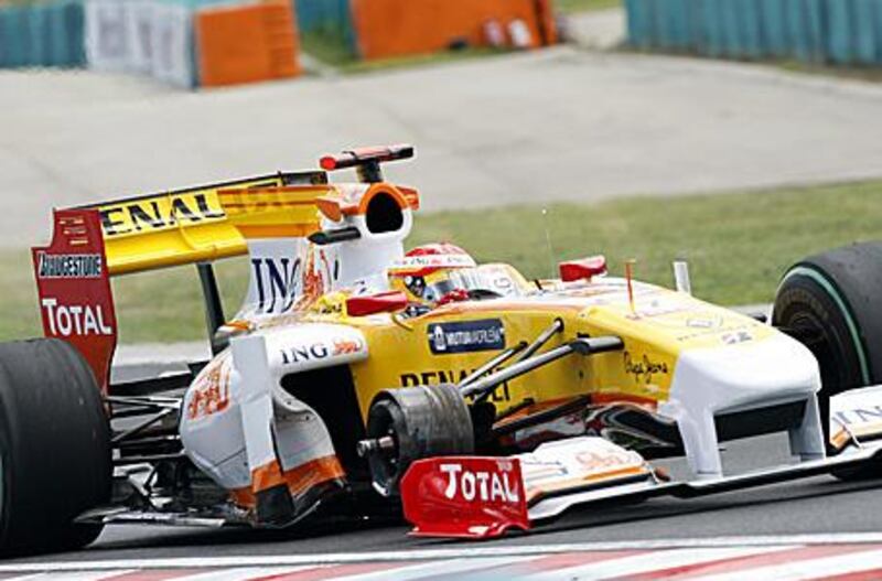 Renault's Spanish driver Fernando Alonso drives on three wheels at the Hungaroring racetrack after he lost one during the Hungarian Grand Prix on Sunday. The French team have been given a one race ban by race stewards for allowing their car to run in an unsafe fashion.