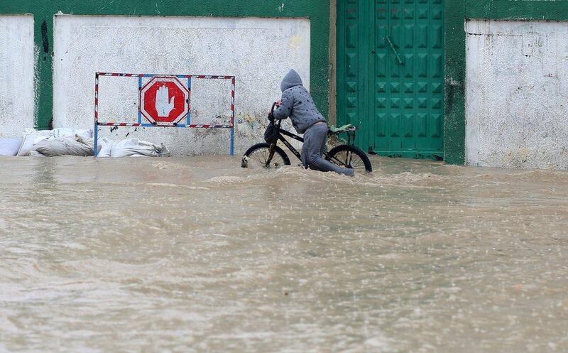 A Palestinian boy pushes his bicycle thorugh floodwaters. Even Gaza with its milder coastal climate saw some snow, though lower-lying areas were mainly hit by flooding. Mohammed Saber / EPA