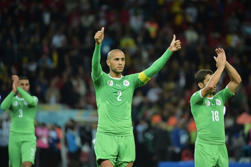 Algeria captain Madjid Bougherra, centre, and forward Abdelmoumene Djabou, right, acknowledge the crowd after their 2-1 loss to Germany at the 2014 World Cup on Monday night. Gabriel Bouys / AFP / June 30, 2014