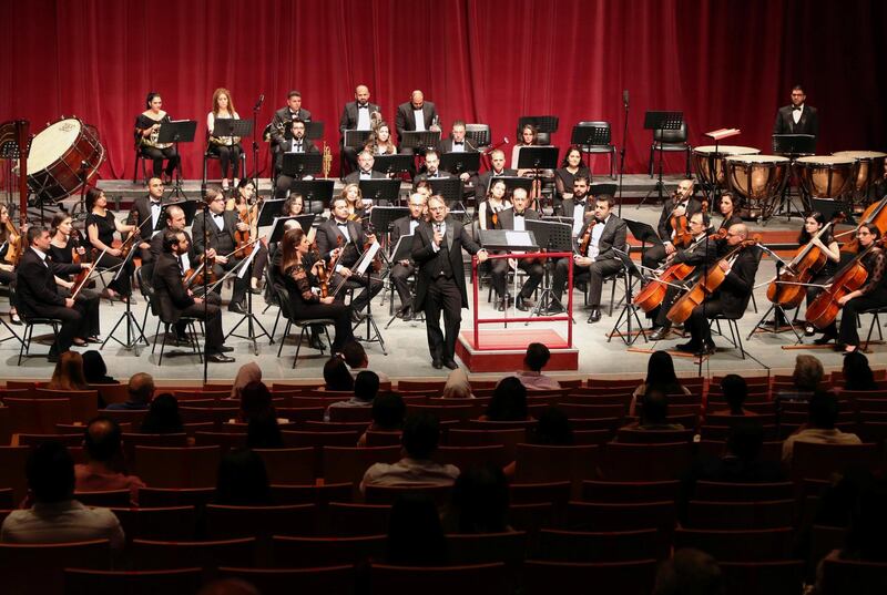 Missak Baghboudarian, a conductor of the Syrian National Symphony Orchestra, speaks to an audience at the Opera House in Damascus, Syria. Reuters