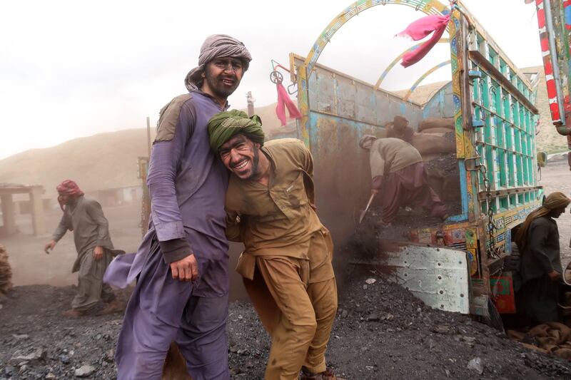 Miners pose for a pictures on International Workers' Day at a coal mine in Quetta, Pakistan. EPA