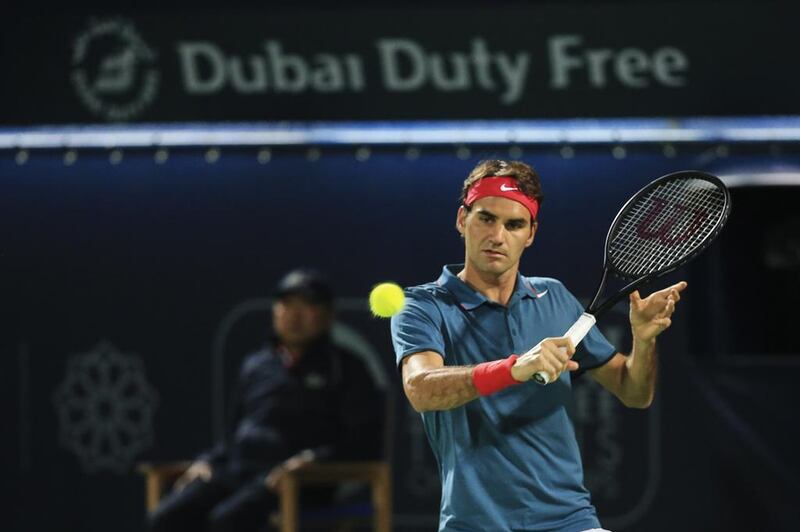 Roger Federer plays a backhand against Novak Djokovic during the semi-finals of the Dubai Duty Free Tennis Championships at Dubai Tennis Stadium on February 28, 2014. Sarah Dea / The National