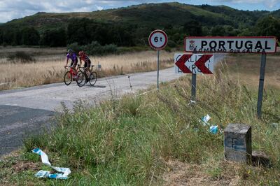 epa08520590 Cyclists cross the border between Spain and Portugal after the official ceremony of borders reopening between two countries in A Xironda, northwestern Spain, 01 July 2020. The borders are opened three and half months after its closing due to the coronavirus disease (COVID-19) pandemic  EPA/BRAIS LORENZO