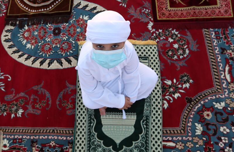 An Emirati schoolboy attends the Eid Al Fitr prayer at Nad Al Hammar in Dubai. EPA