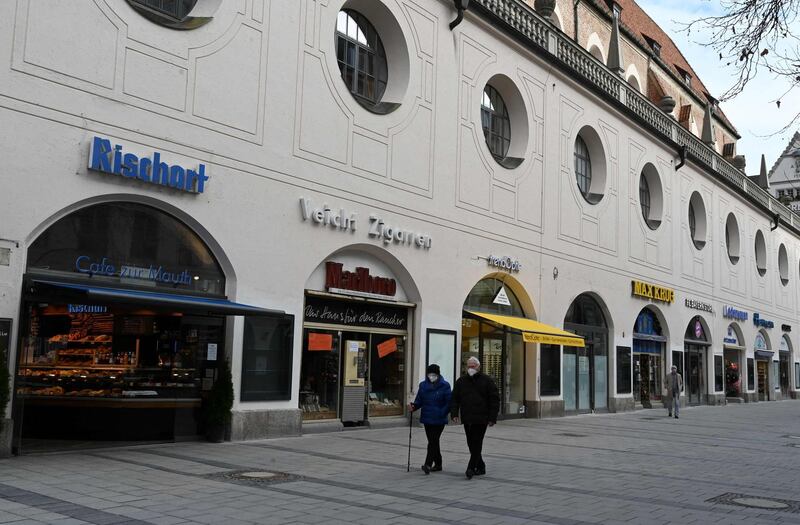 (FILES) In this file photo taken on February 08, 2021 only few people walk in a shopping street in downtown of Munich, southern Germany, whose shops are closed, amid the ongoing novel coronavirus / Covid-19 pandemic.  People who have been fully vaccinated against Covid-19 will no longer have to abide by curfews and contact restrictions in Germany under a draft law agreed by the cabinet on Mai 4, 2021. / AFP / Christof STACHE
